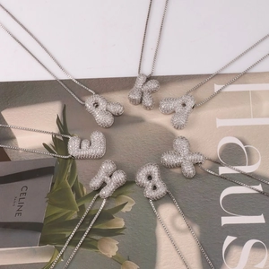 Puffy 3D bubble initial necklaces with sparkling micro CZ inlay on stylish background