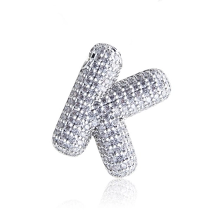 Detailed macro view of silver letter K pendant featuring micro-set zircon stones