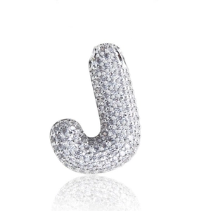 Macro shot of silver bubble letter J pendant with shimmering pavé zircon stones