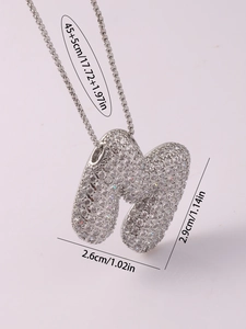 Detail of silver balloon letter M pendant with paved crystals and size measurements