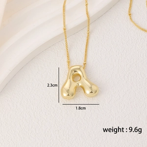 Detail of gold bubble letter A pendant necklace with high-shine polished finish