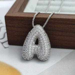 Close-up of a bubble letter A pendant with clear cubic zirconia in silver finish
