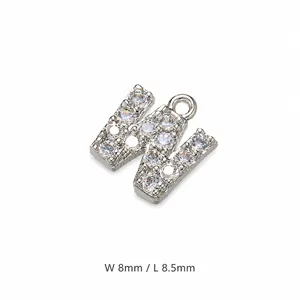 Detailed macro view of silver letter W pendant with cubic zirconia inlay, 8x8.5mm size