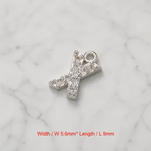 Macro view of silver letter X pendant with cubic zirconia, size 5.6mm by 9mm