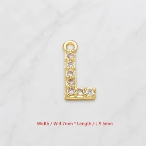 Macro detail of gold letter L pendant with zircon stones, measuring 4.7mm by 9.5mm