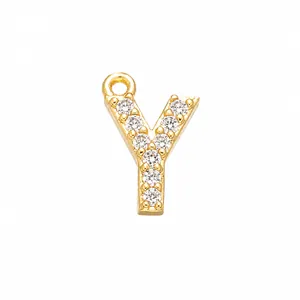Macro detail of gold-plated letter Y pendant with inlaid white cubic zirconia stones