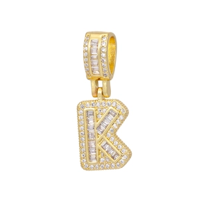 Close-up of golden letter K pendant with baguette-cut and round-cut cubic zirconia