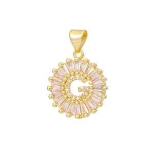 Detailed macro view of 18k gold letter G pendant with sparkling cubic zirconia settings
