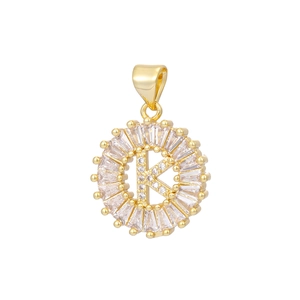 Detail of 18k gold plated letter K pendant with baguette and round cubic zirconia stones