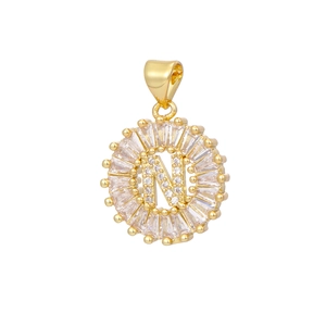 Macro shot of gold-plated letter N pendant with circular halo of baguette cubic zirconia
