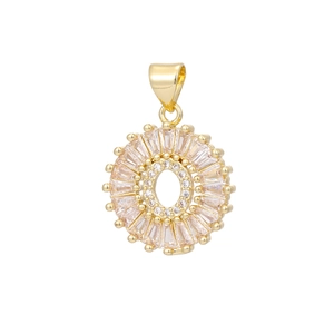 Macro detail of sunburst 18k gold plated pendant with baguette cubic zirconia crystals