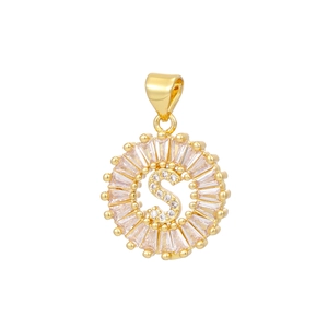 Macro shot of 18k gold plated letter S pendant with baguette and round cubic zirconia