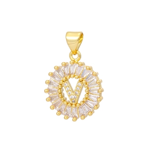 Detailed macro view of gold plated letter V pendant with baguette cut cubic zirconia stones