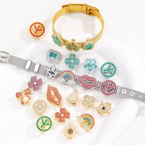 Macro detail of various colorful zircon charms on a 10mm stainless steel mesh bracelet