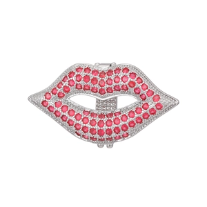 Detailed view of lip-shaped accessory featuring vibrant red crystals and silver setting
