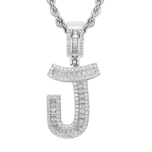 Macro shot of silver-tone letter J hip hop pendant with cubic zirconia and rope chain