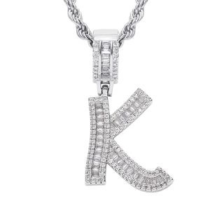 Close-up of hip hop letter K pendant with baguette cut cubic zirconia and rope chain