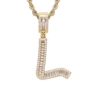 Macro view of gold-plated hip-hop letter L pendant encrusted with cubic zirconia stones