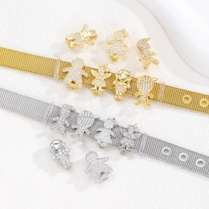 Detailed macro of crystal zircon paved doll charms on mesh belt bracelet straps