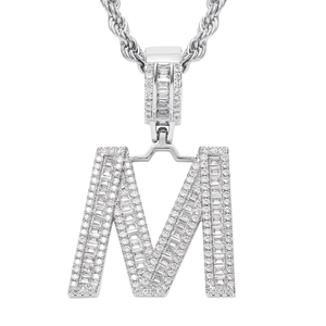 Close-up of letter M hiphop pendant with paved round and baguette cubic zirconia stones