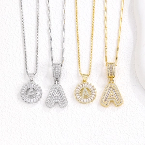 Iced out zircon letter A pendant necklaces in gold and silver set on white background