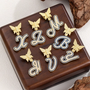Iced out gold alphabet butterfly pendant necklace with blue and white stones
