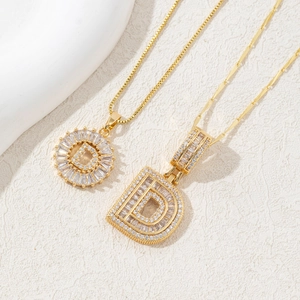 Golden necklace set with letter D pendant featuring sparkling cubic zirconia stones