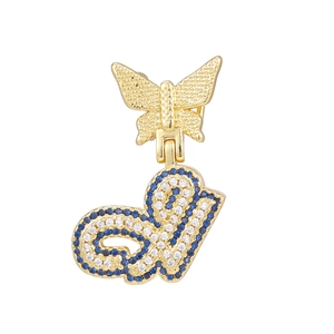 Macro detail of golden butterfly pendant with blue and white zircon pavé letter J