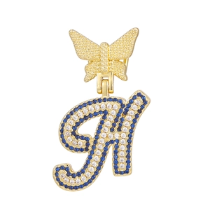 Close-up of golden butterfly letter H pendant with multi-colored zircon stones