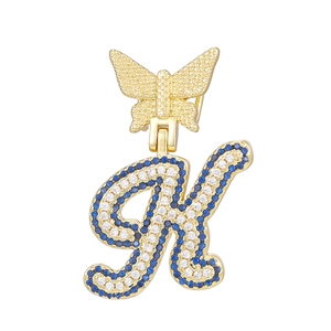 Detailed view of gold letter K butterfly pendant with blue and white pavé crystals