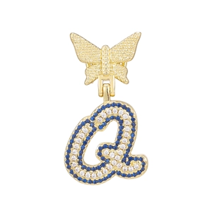 Detailed close-up of a gold-plated butterfly pendant with letter Q and blue zircon stones