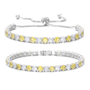 Dettaglio di bracciali tennis con zirconi gialli e bianchi alternati su base argento