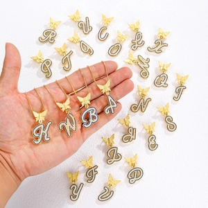 Gold butterfly initial necklace with blue and white crystals on a gold chain