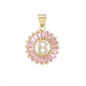 Macro detail of golden letter B pendant with pink baguette zircons and white crystals