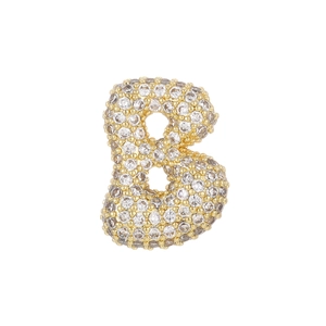 Macro detail of gold-plated letter B pendant with micro-pave cubic zirconia stones