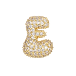 Macro shot of 18k gold plated bubble letter E pendant encrusted with sparkling cubic zirconia