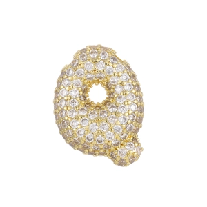 Macro detail of 18k gold plated letter Q pendant with micro-paved sparkling zircon stones