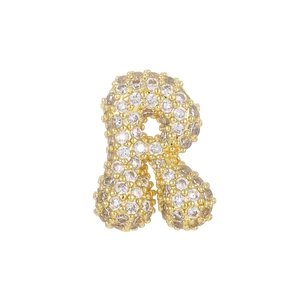 Macro detail of 18k gold plated balloon letter R pendant with pave-set zircon stones