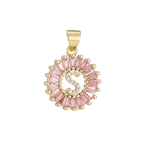 Detailed macro of gold plated letter S pendant with pink stones and zircons