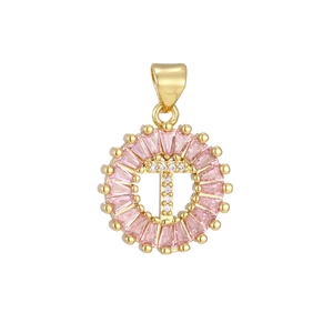 Macro view of gold-plated letter T pendant with pink baguette stones and white zircons
