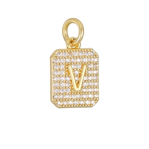 Detail van een gouden rechthoekige hanger met zirkonia en hoofdletter V