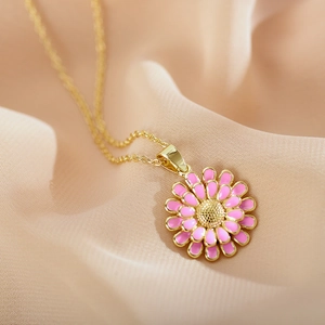 Detailed close-up of pink enamel daisy pendant on a delicate gold chain for women
