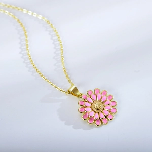 Detailed close-up of double-layered pink sunflower pendant with gold-plated edges