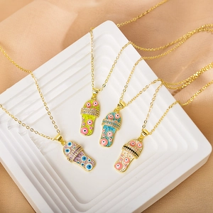 Detail of colorful slipper pendants with evil eye pattern and rhinestones on gold chains