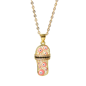 Detail of gold slipper pendant necklace with evil eye enamel and cubic zirconia stones