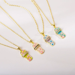 Close-up of colorful enamel slipper pendants with evil eye pattern and zircon stones