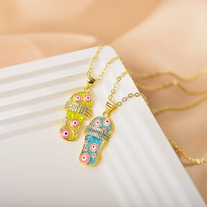 Detail of gold evil eye slipper pendants with enamel finish and sparkling cubic zirconia