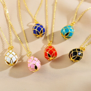 Detail of six colorful egg-shaped enamel pendants with gold lattice on fine chains