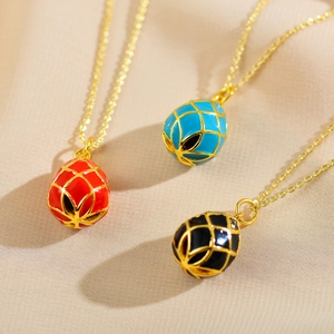Three elegant enamel planet pendants with gold lattice patterns on a fine chain