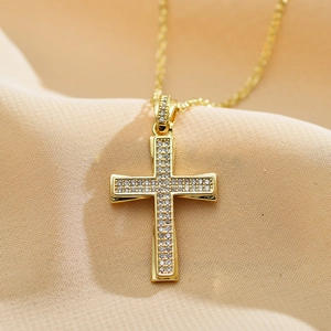 Close-up of gold-plated cross pendant necklace with micro-pave white zircon stones